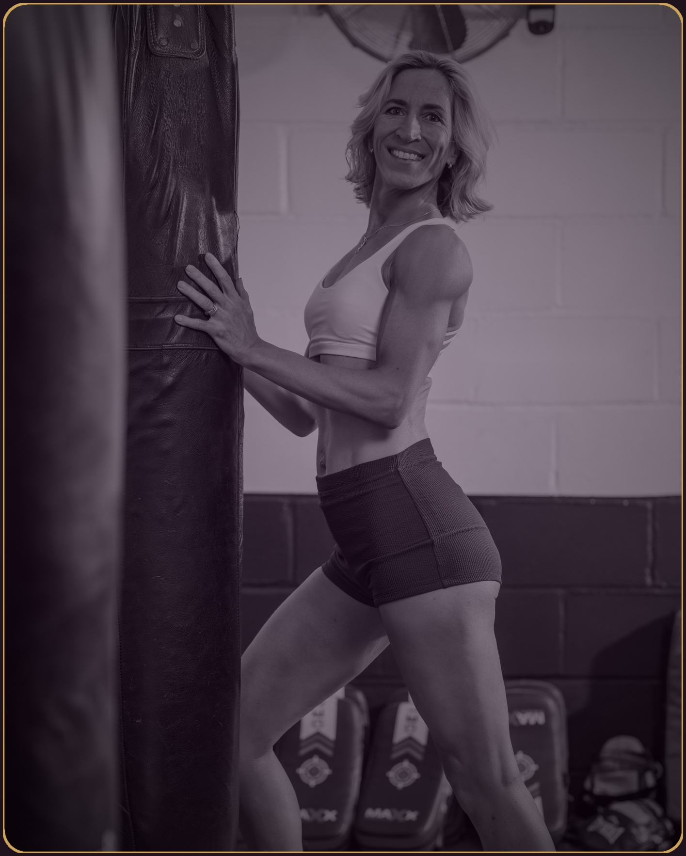 Natasha Evans training with a punching bag — strong, centred, unapologetic